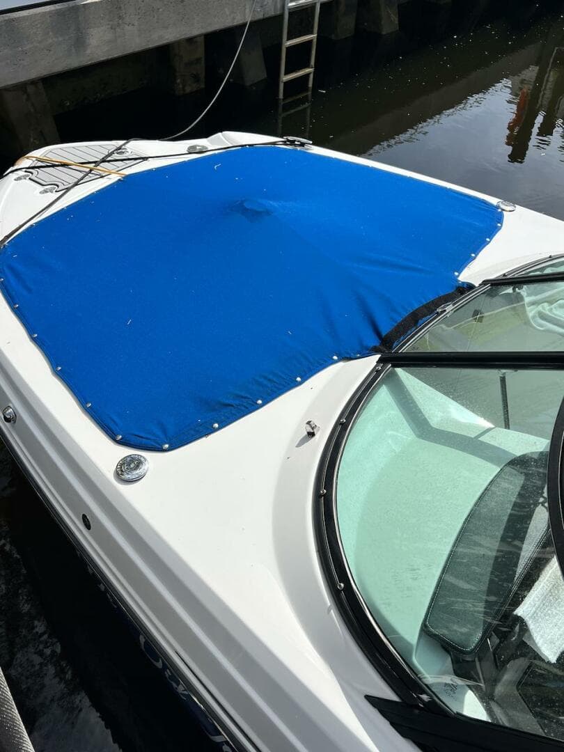 2022 Monterey M-45 boat with blue cover docked at marina.