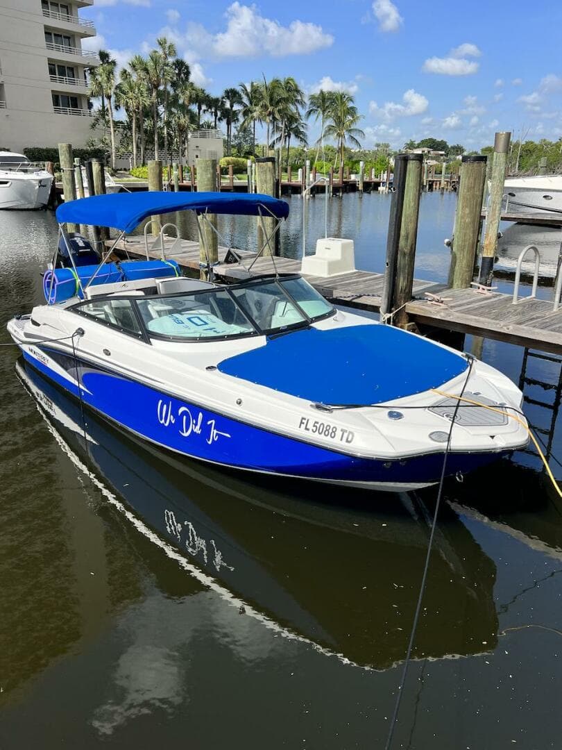 2022 Monterey M-45 boat docked at a marina with blue canopy and cover.