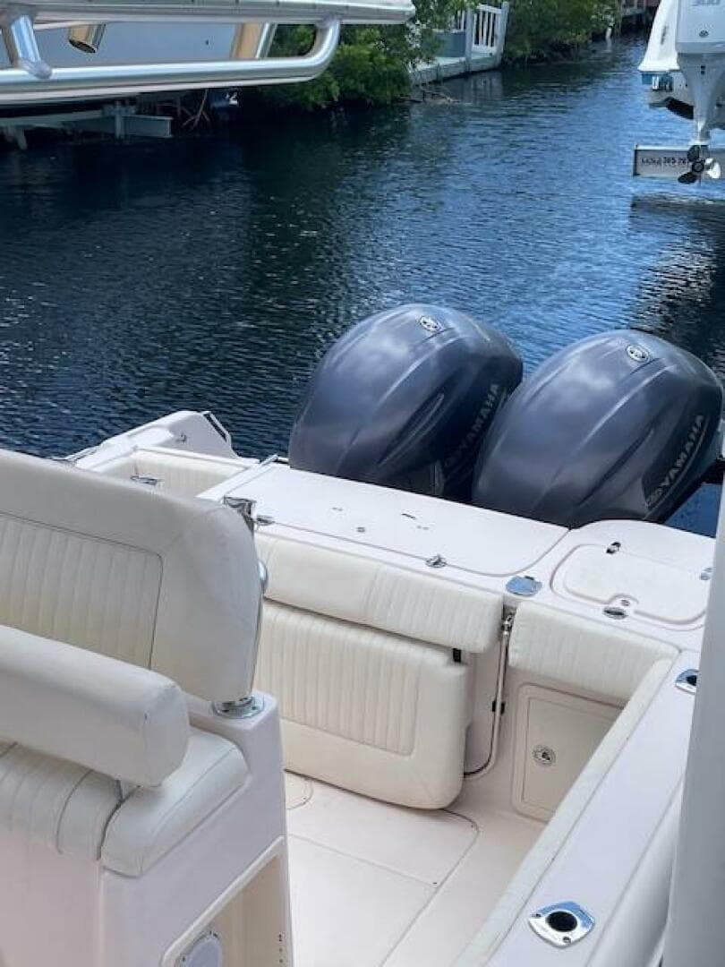 2014 Grady-White Fisherman 257 boat with twin outboard engines docked on calm water.