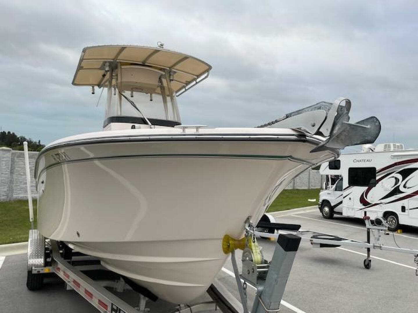 2014 Grady-White Fisherman 257 boat on trailer in parking lot.