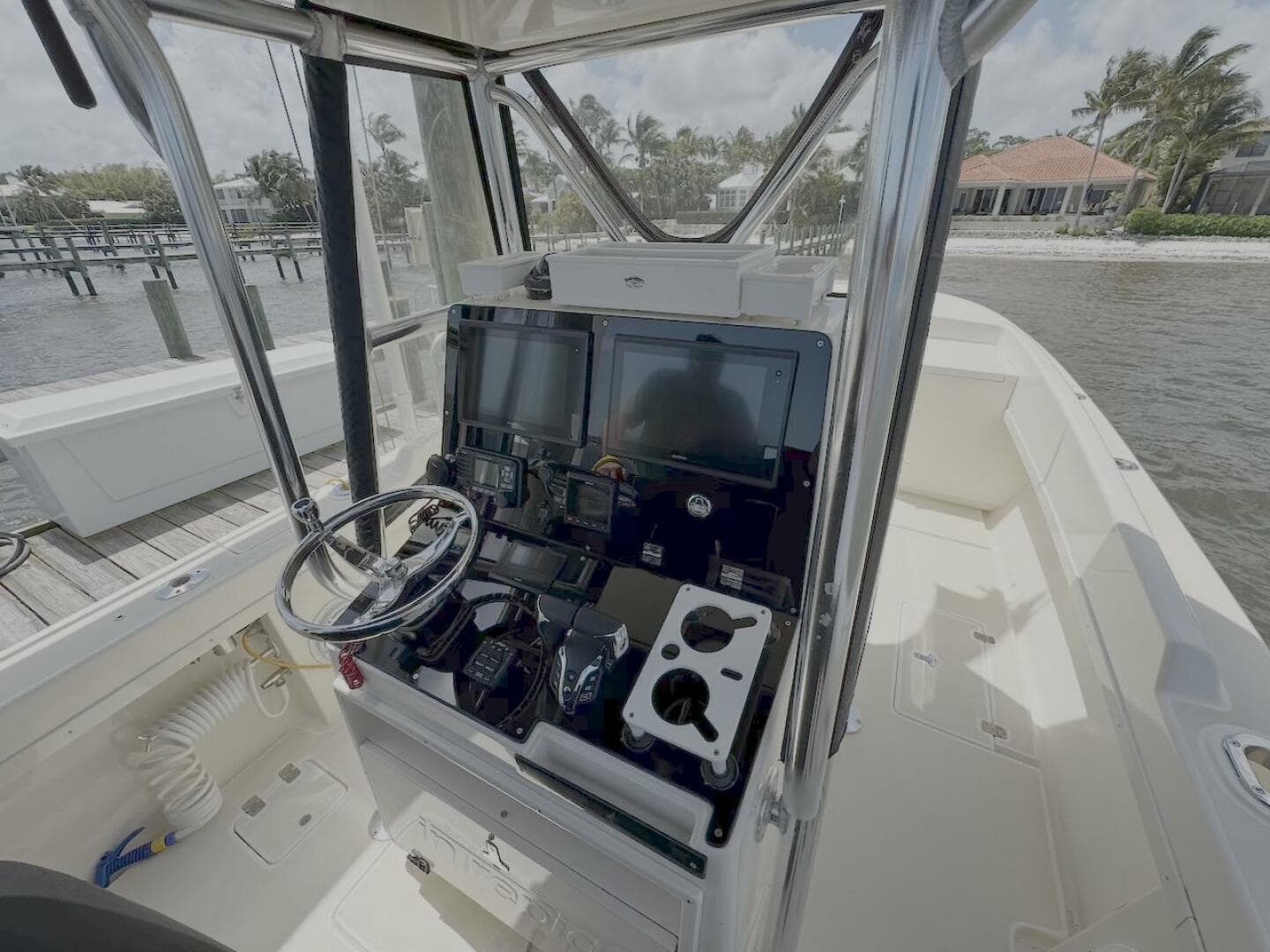 2004 Intrepid 32 Cuddy boat cockpit with steering wheel and navigation equipment.