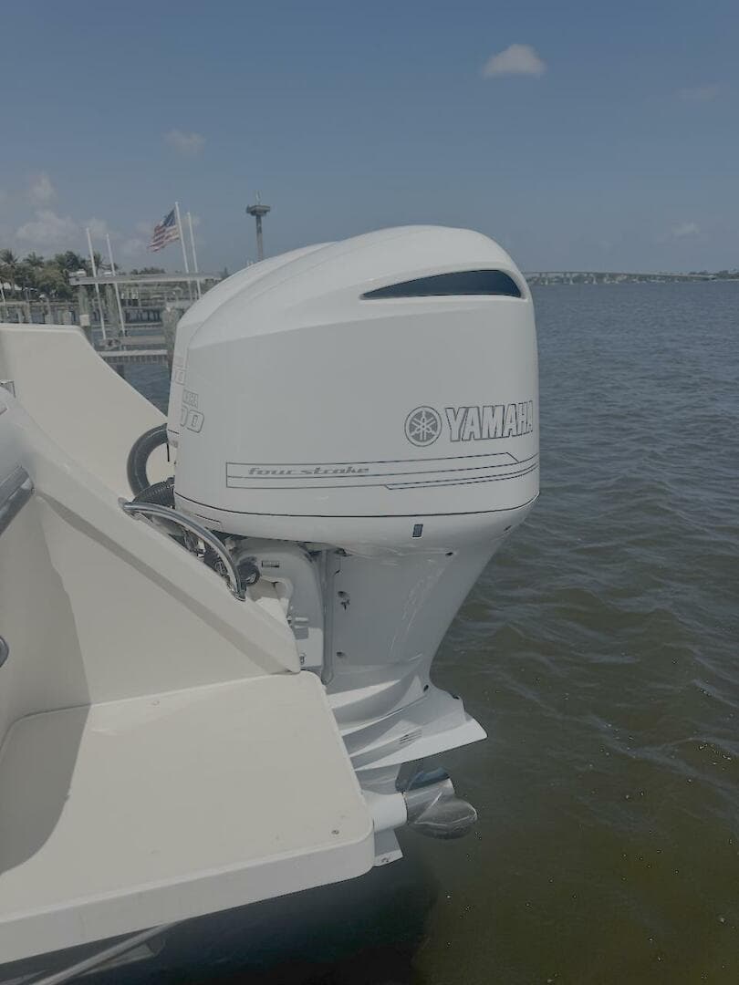 2004 Intrepid 32 Cuddy with Yamaha outboard engine on calm water.