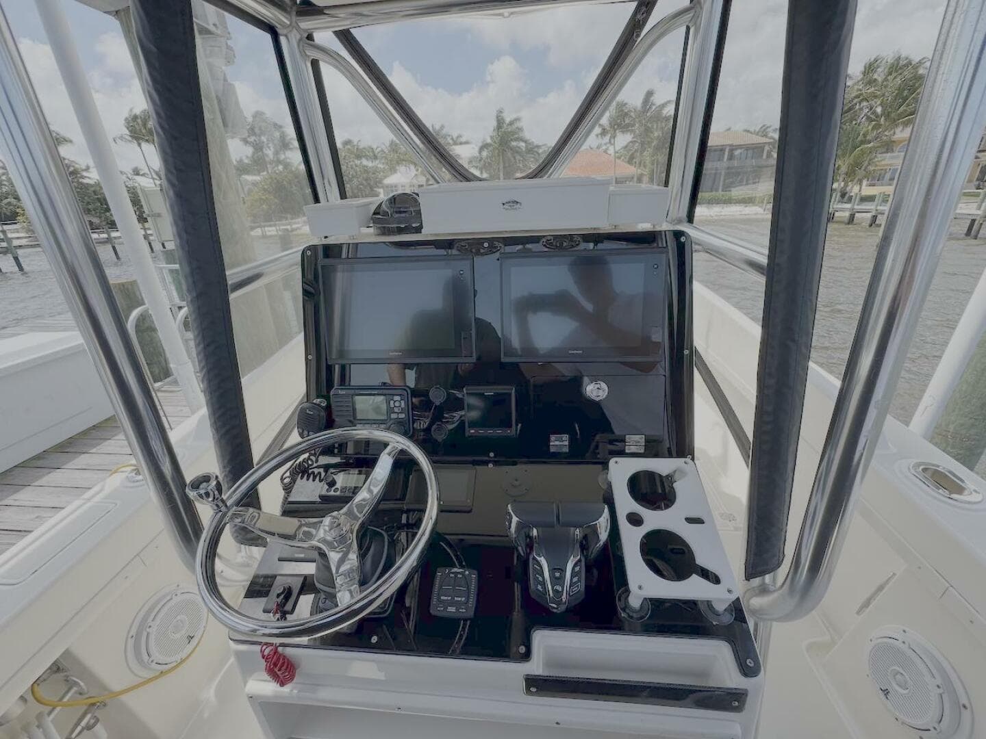 2004 Intrepid 32 Cuddy boat helm with steering wheel and navigation controls.