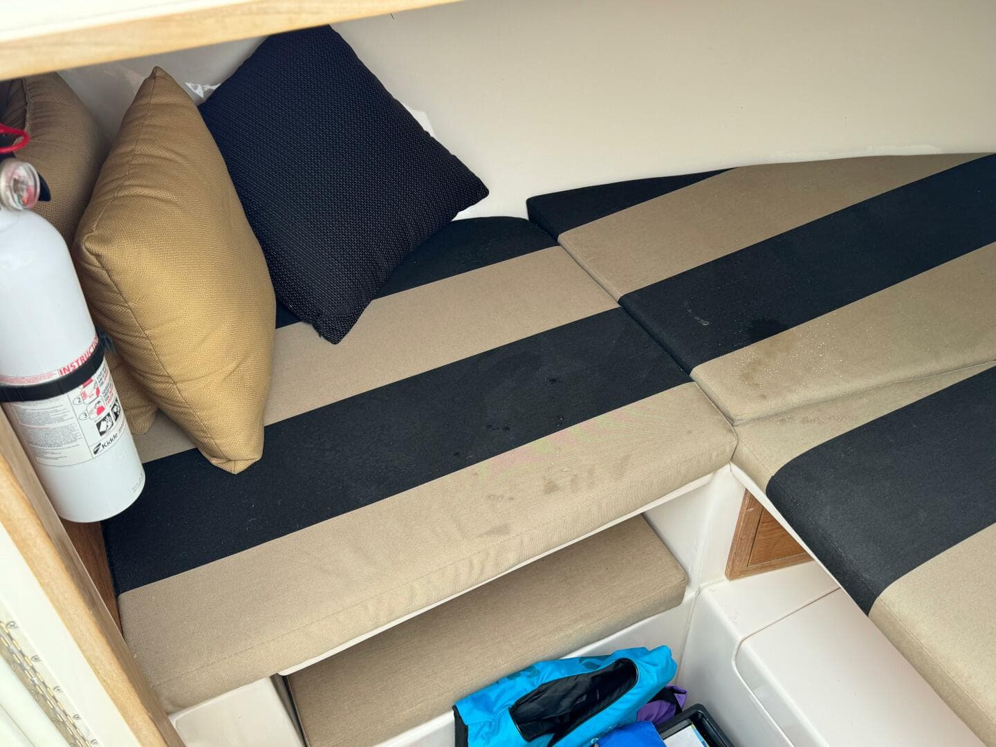 2004 Intrepid 32 Cuddy cabin interior with striped cushions and pillows.