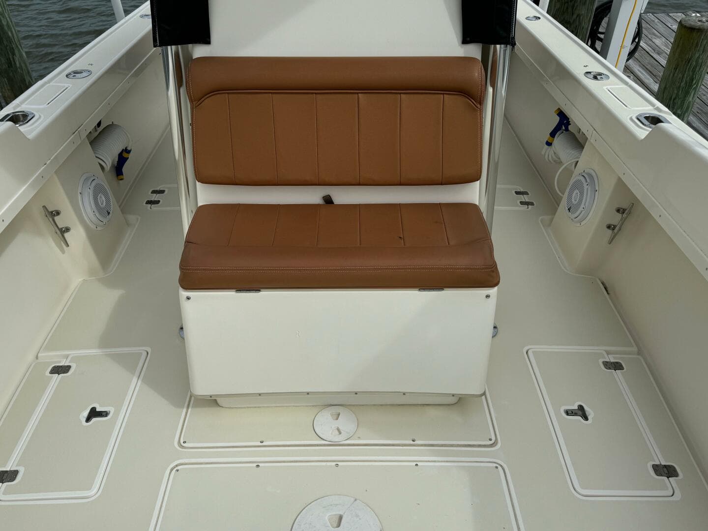 2004 Intrepid 32 Cuddy boat interior with tan seating and storage compartments.