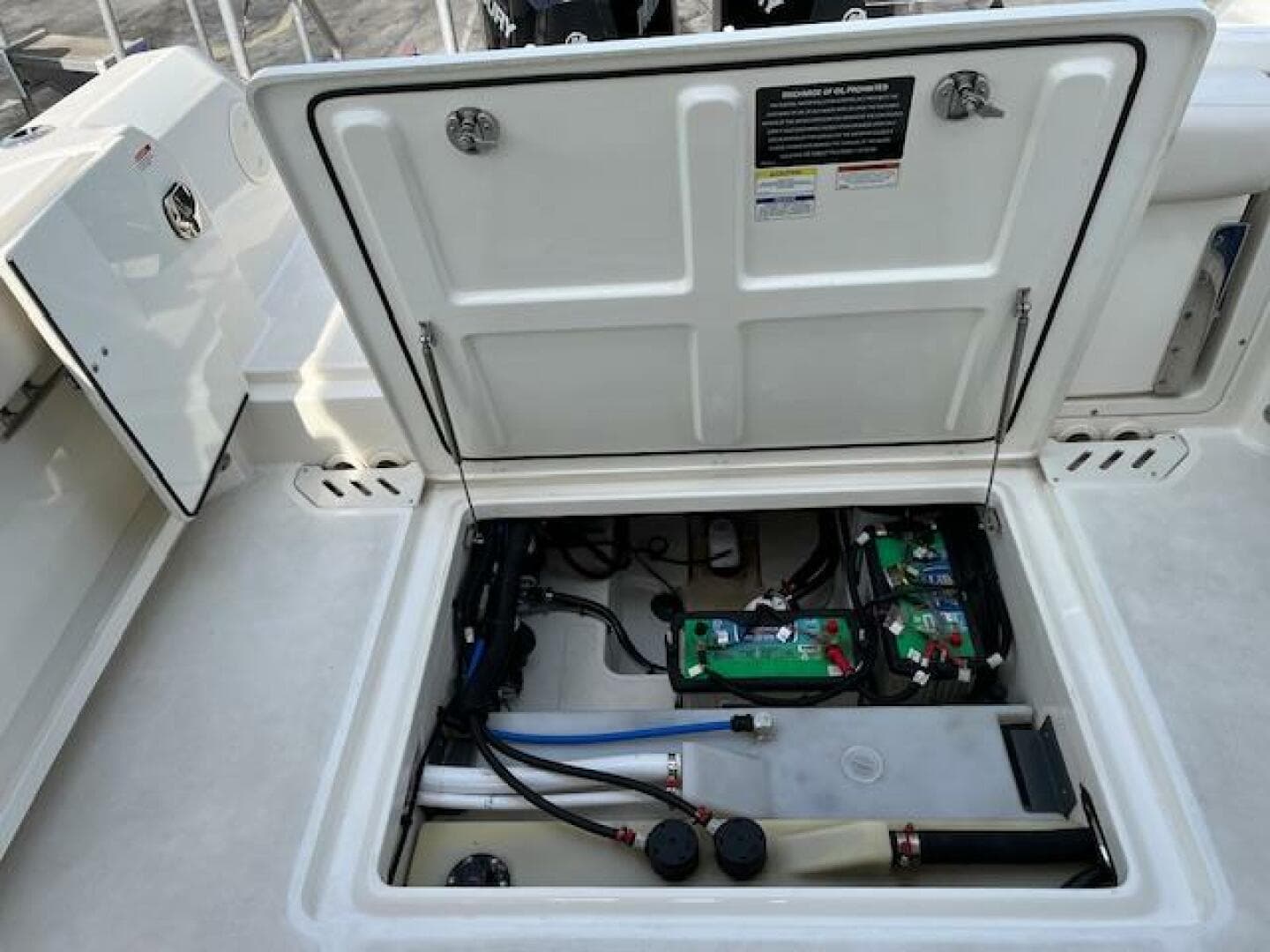 2018 Boston Whaler 270 Vantage open hatch showing battery compartment and wiring.