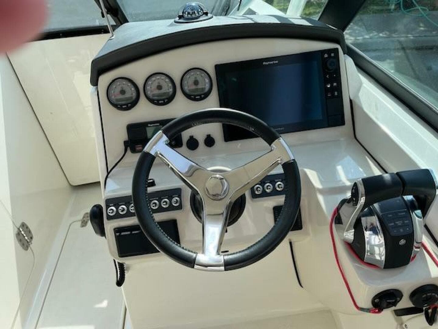 2018 Boston Whaler 270 Vantage helm with steering wheel, gauges, and controls.