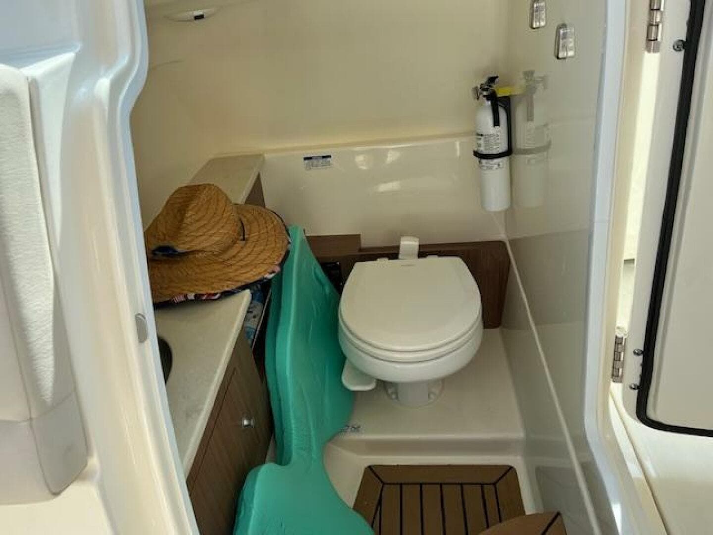 2018 Boston Whaler 270 Vantage boat interior with toilet and storage area.