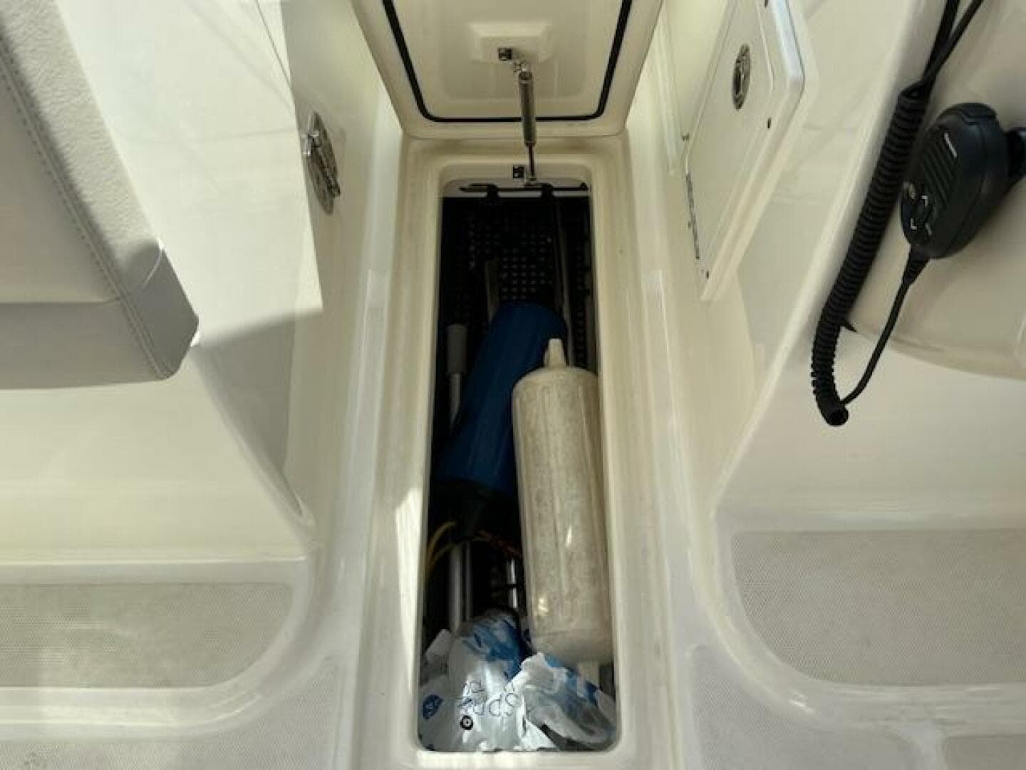 Storage compartment of a 2018 Boston Whaler 270 Vantage boat with various equipment.