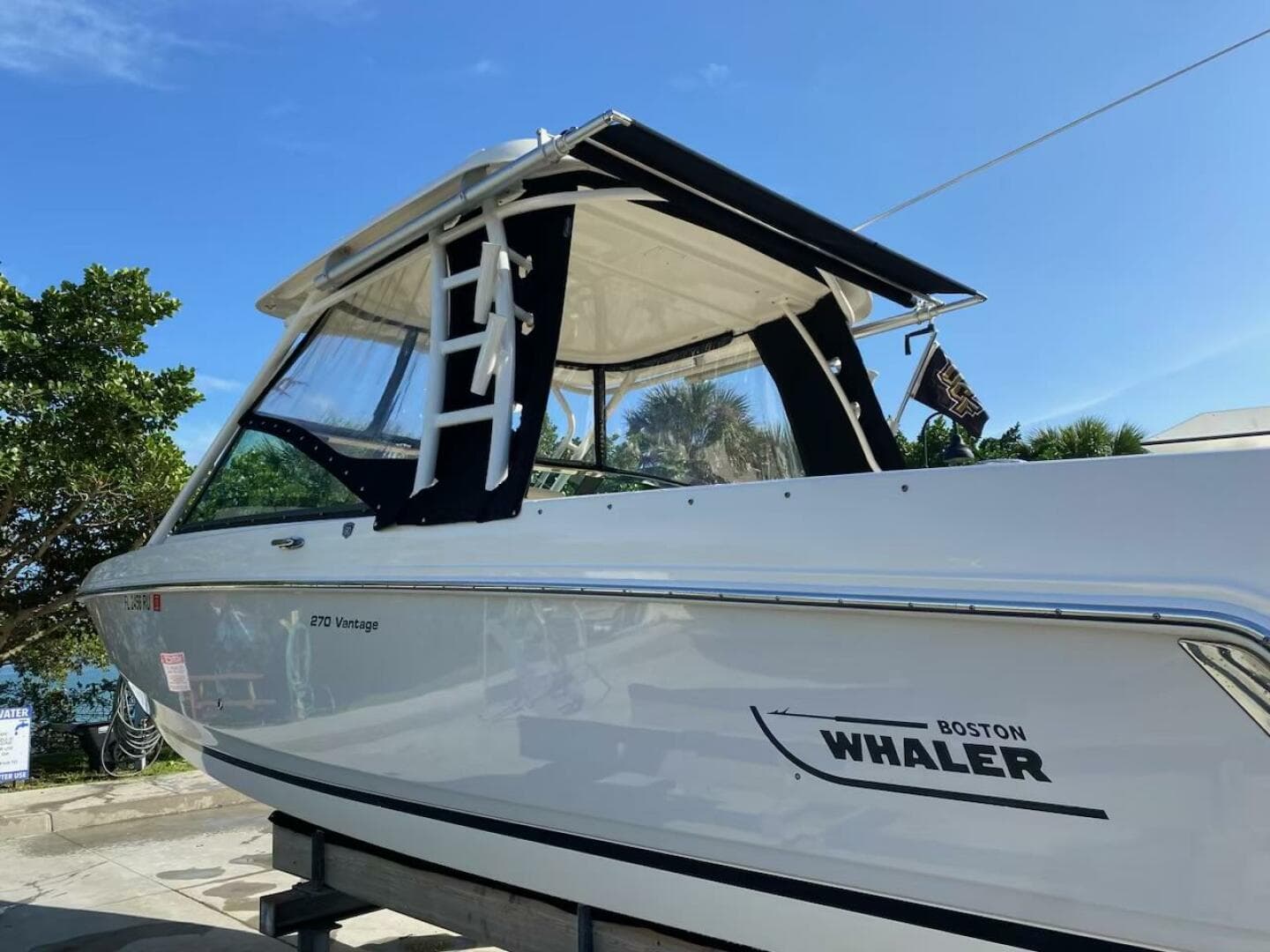 2018 Boston Whaler 270 Vantage boat on a trailer under a clear blue sky.
