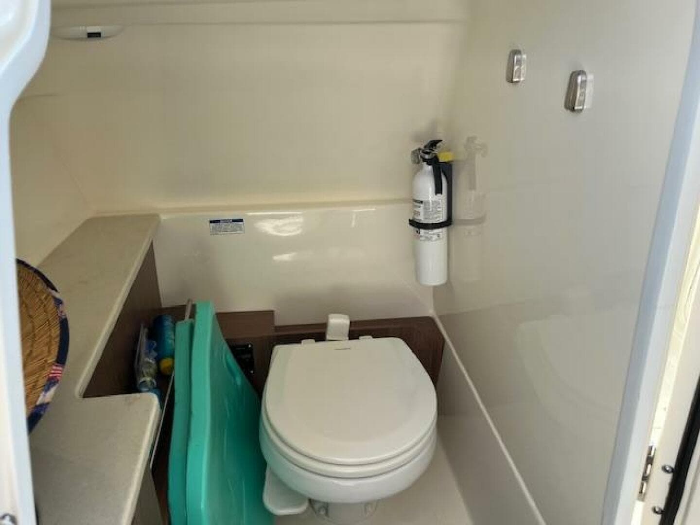 2018 Boston Whaler 270 Vantage boat interior bathroom with toilet and fire extinguisher.