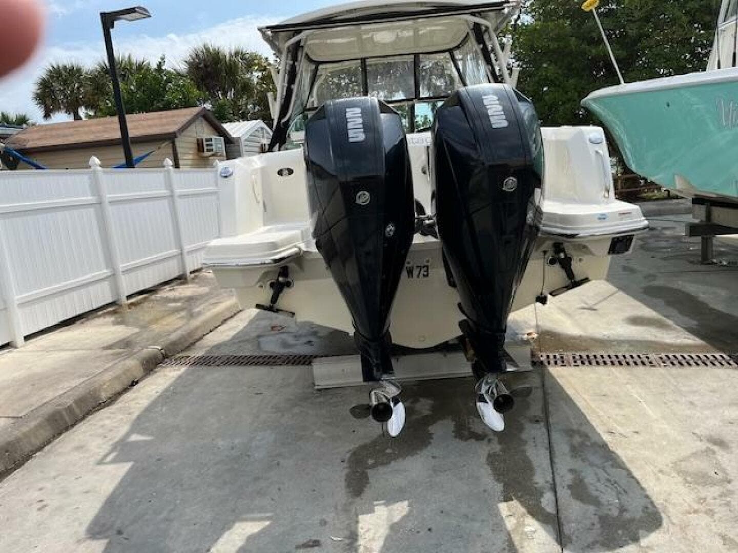 2018 Boston Whaler 270 Vantage with dual outboard engines at a dock.