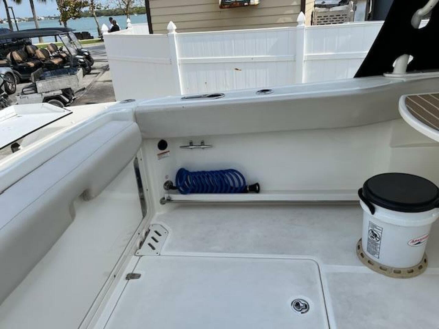 2018 Boston Whaler 270 Vantage boat interior with storage and coiled hose.