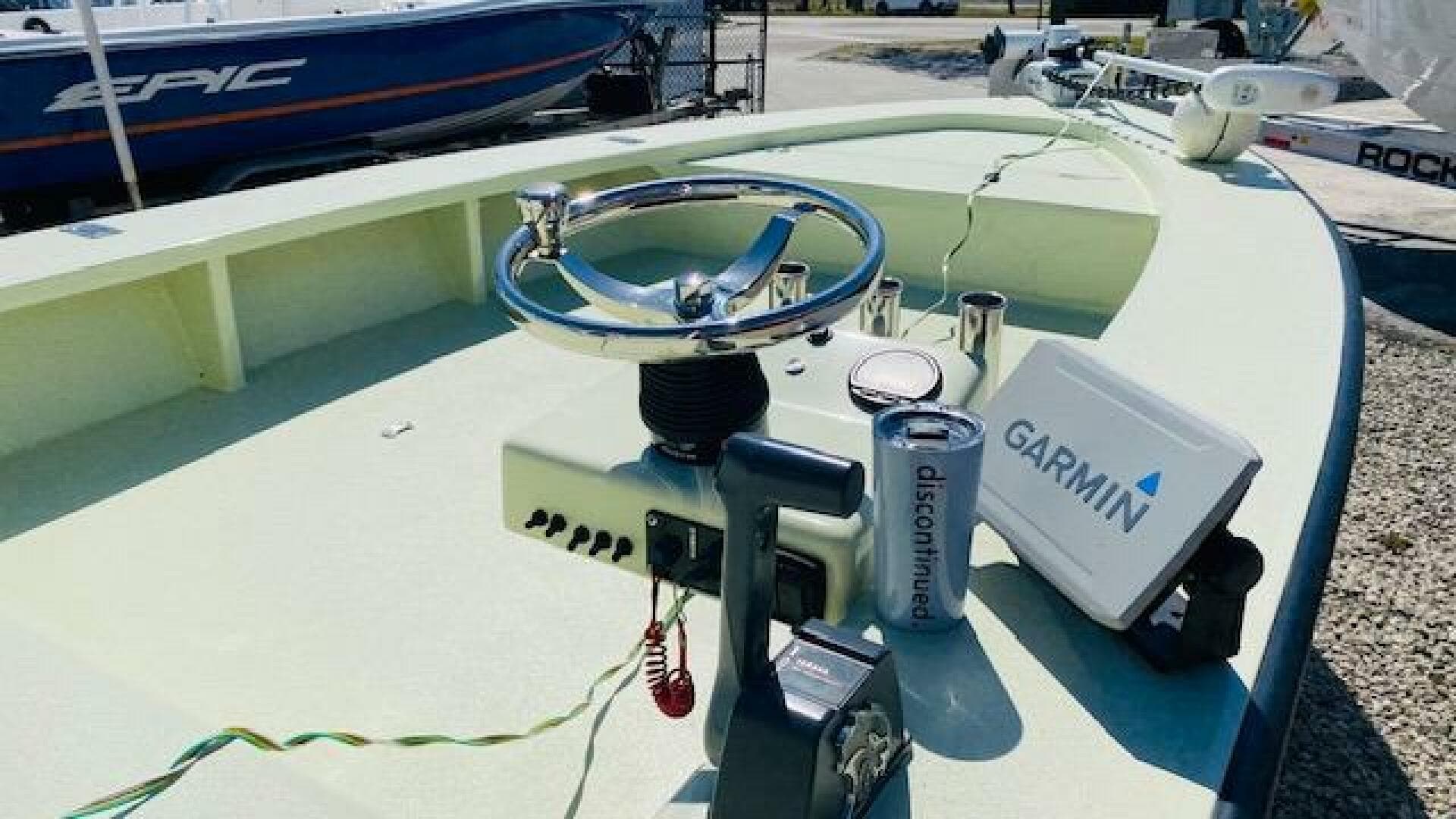 1983 Maverick 18 Flats Boat with Garmin navigation system and steering wheel.