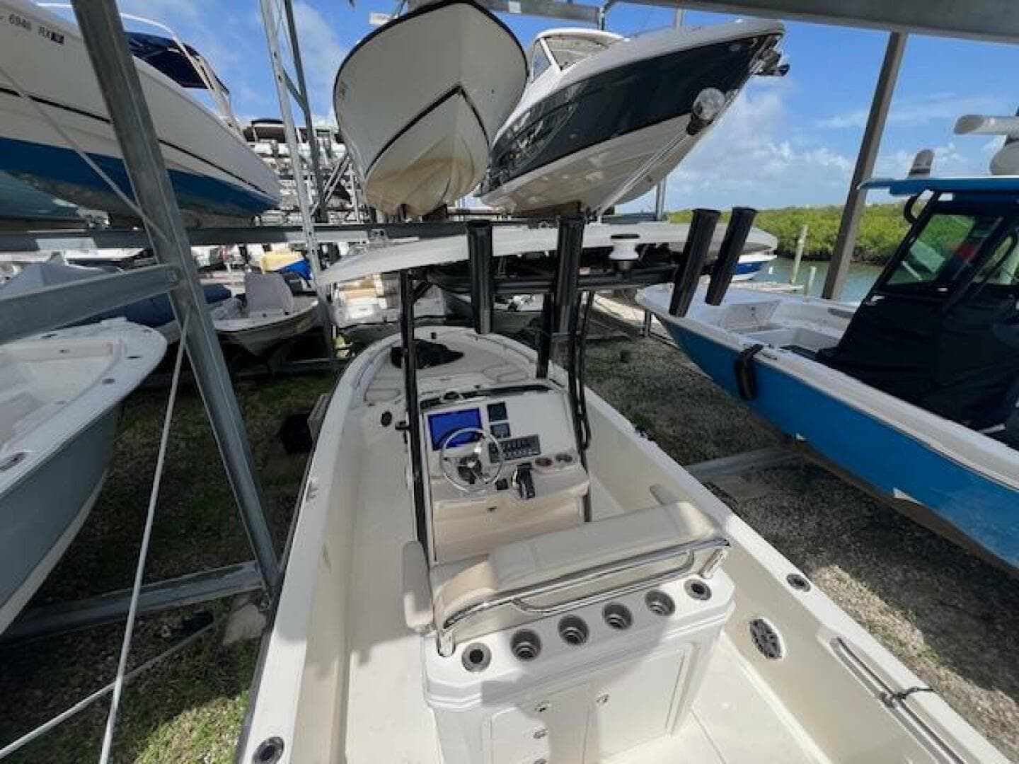 2023 Boston Whaler 250 Dauntless boat in storage, surrounded by other vessels.