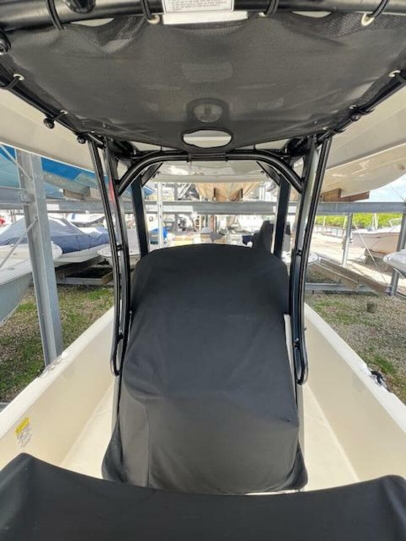 2023 Boston Whaler 250 Dauntless boat interior with covered seating and canopy.