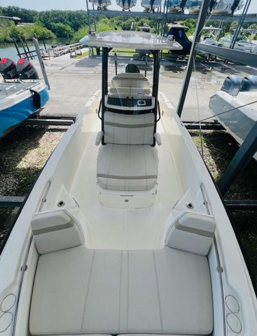 2023 Boston Whaler 250 Dauntless boat, sleek design, spacious seating, docked outdoors.