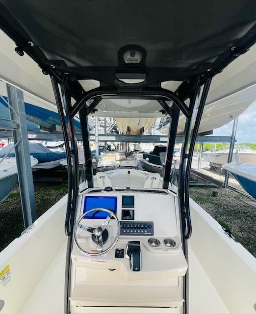 2023 Boston Whaler 250 Dauntless boat interior with steering console and navigation equipment.