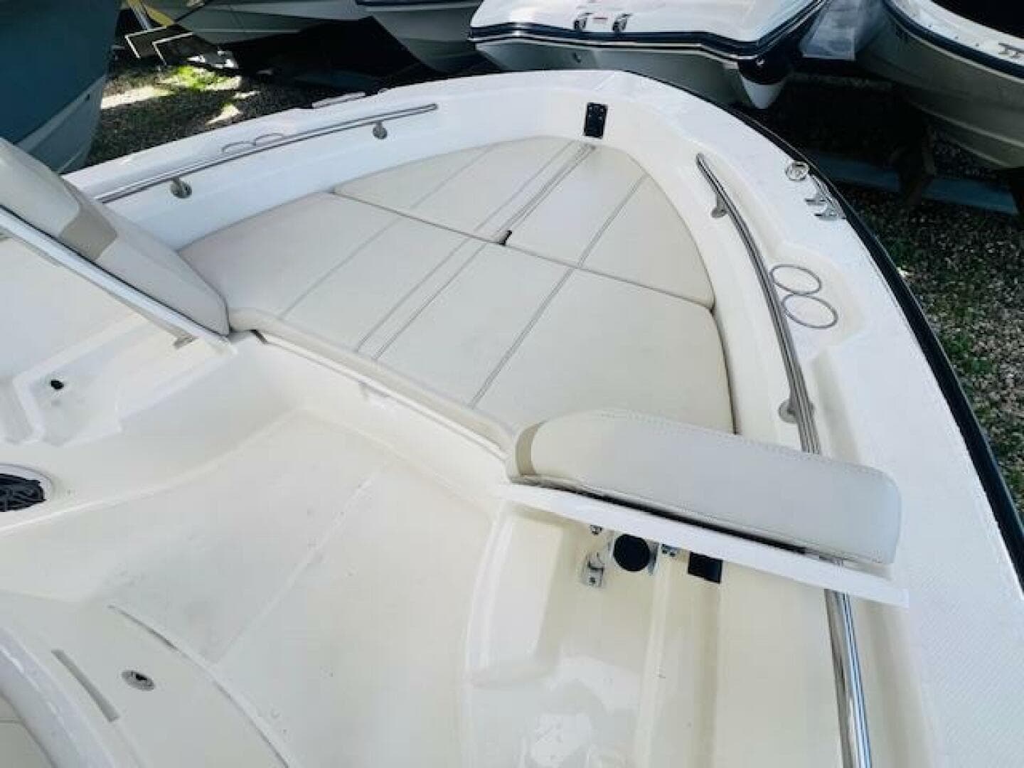 2023 Boston Whaler 250 Dauntless boat interior with cushioned seating and stainless steel railings.