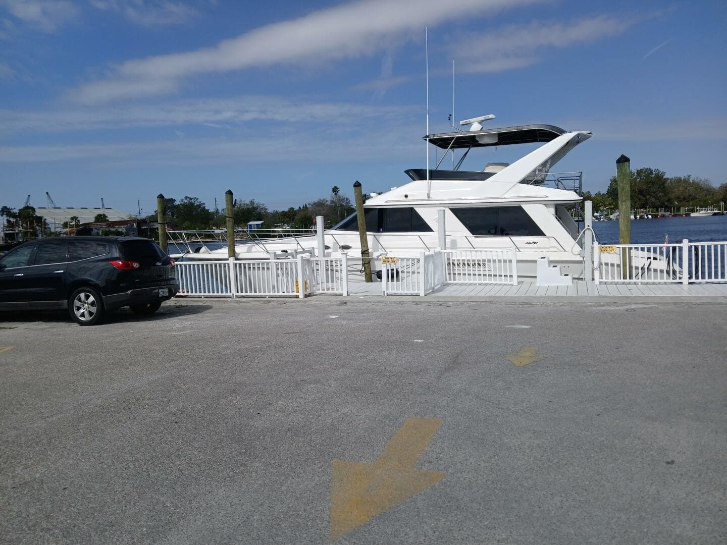 1997 Sea Ray 550 Sedan Bridge yacht docked near a parking lot.