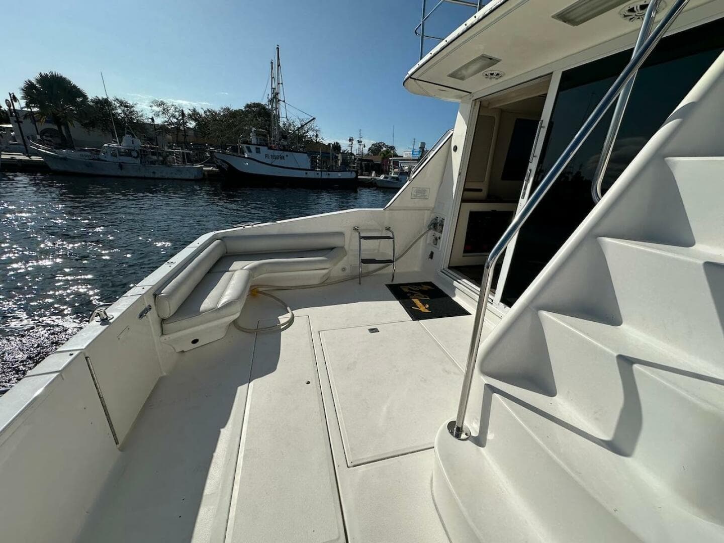 1997 Sea Ray 550 Sedan Bridge yacht deck with marina view.