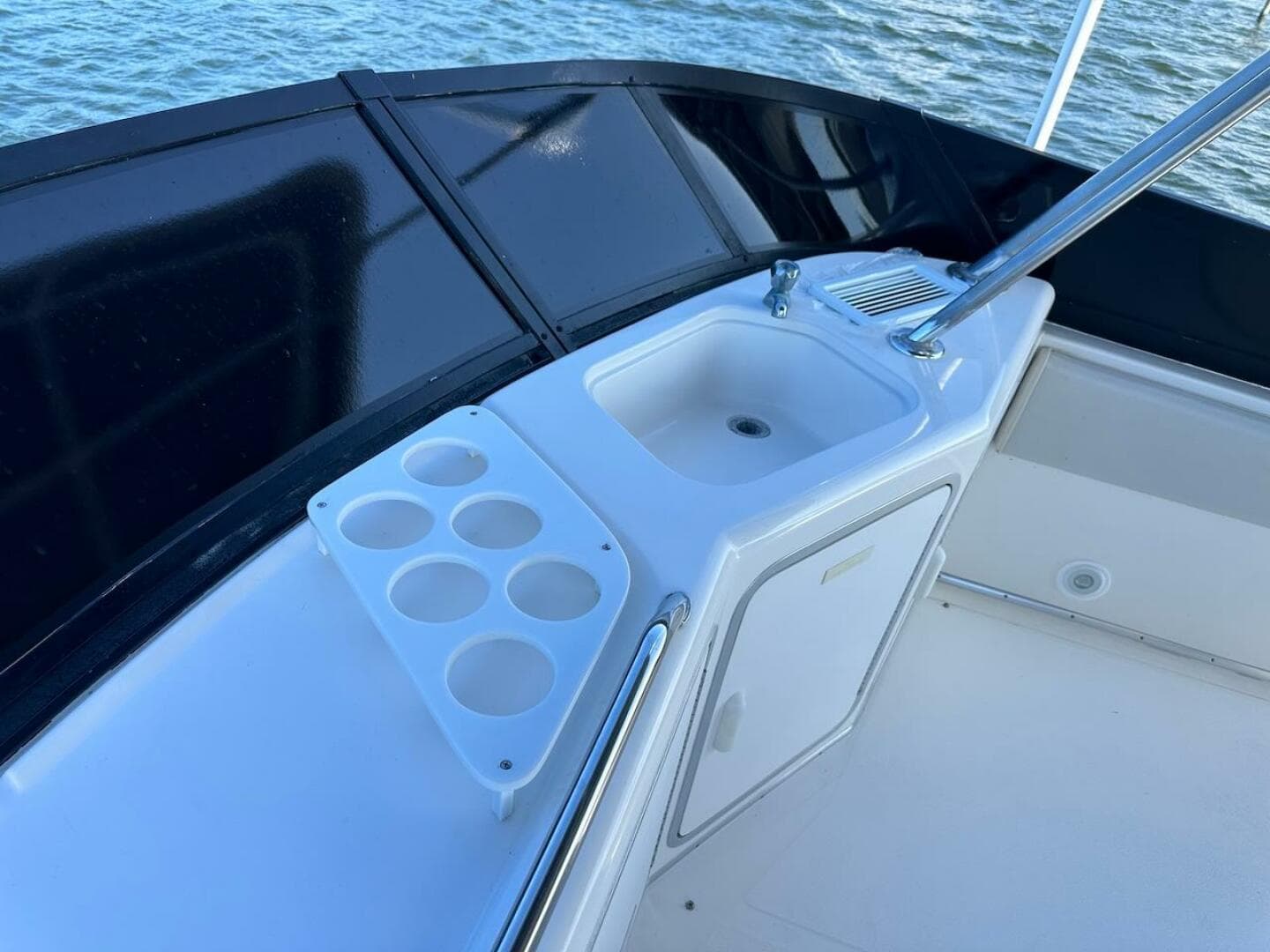 1997 Sea Ray 550 Sedan Bridge deck with sink and cup holders.