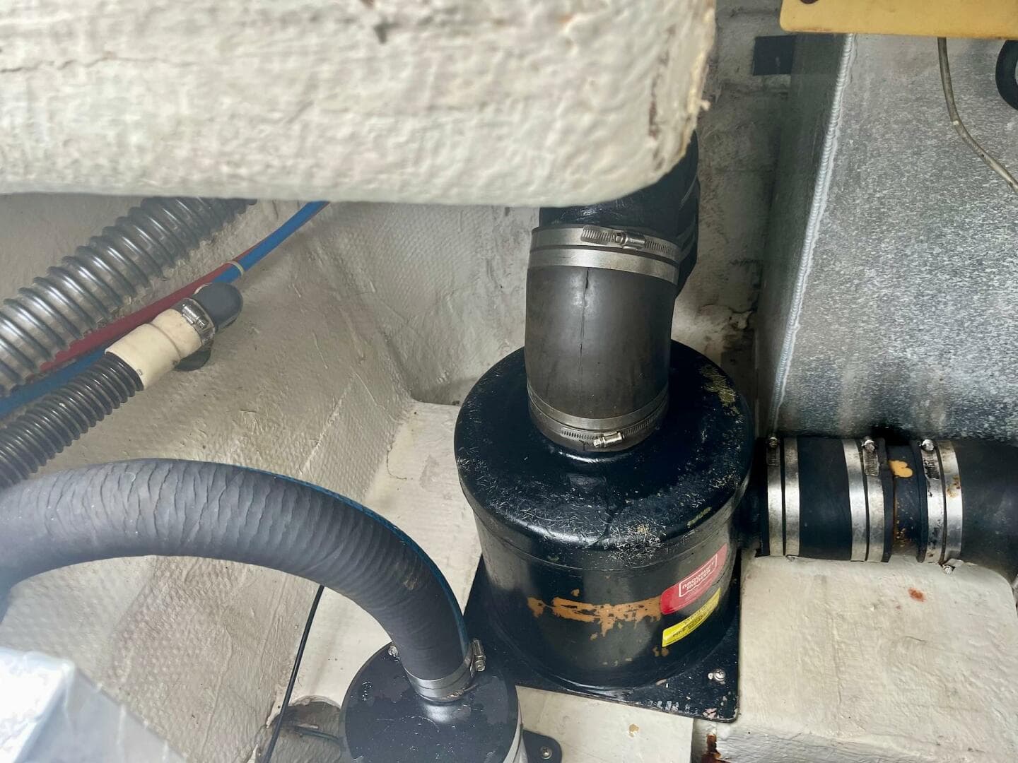 Engine compartment of a 2003 Regal Commodore 3860 boat showing hoses and fittings.