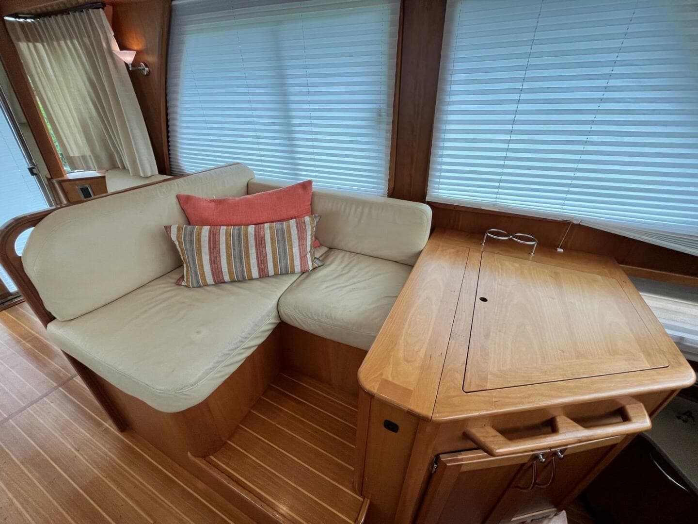 Interior of 2013 Sabre 48 Salon Express with cozy seating and wooden table.