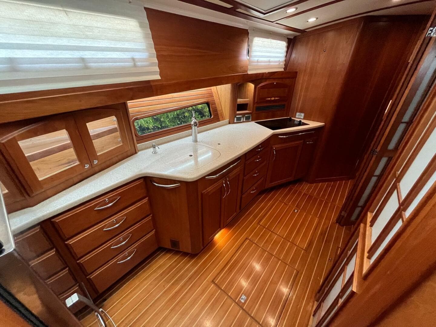 Luxurious kitchen interior of 2013 Sabre 48 Salon Express yacht with wood cabinetry.
