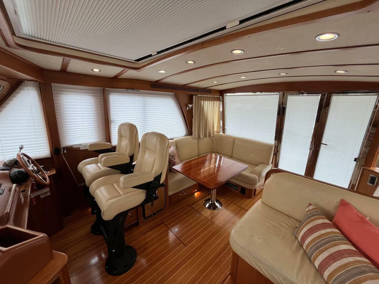 Interior of 2013 Sabre 48 Salon Express yacht with plush seating and wooden accents.