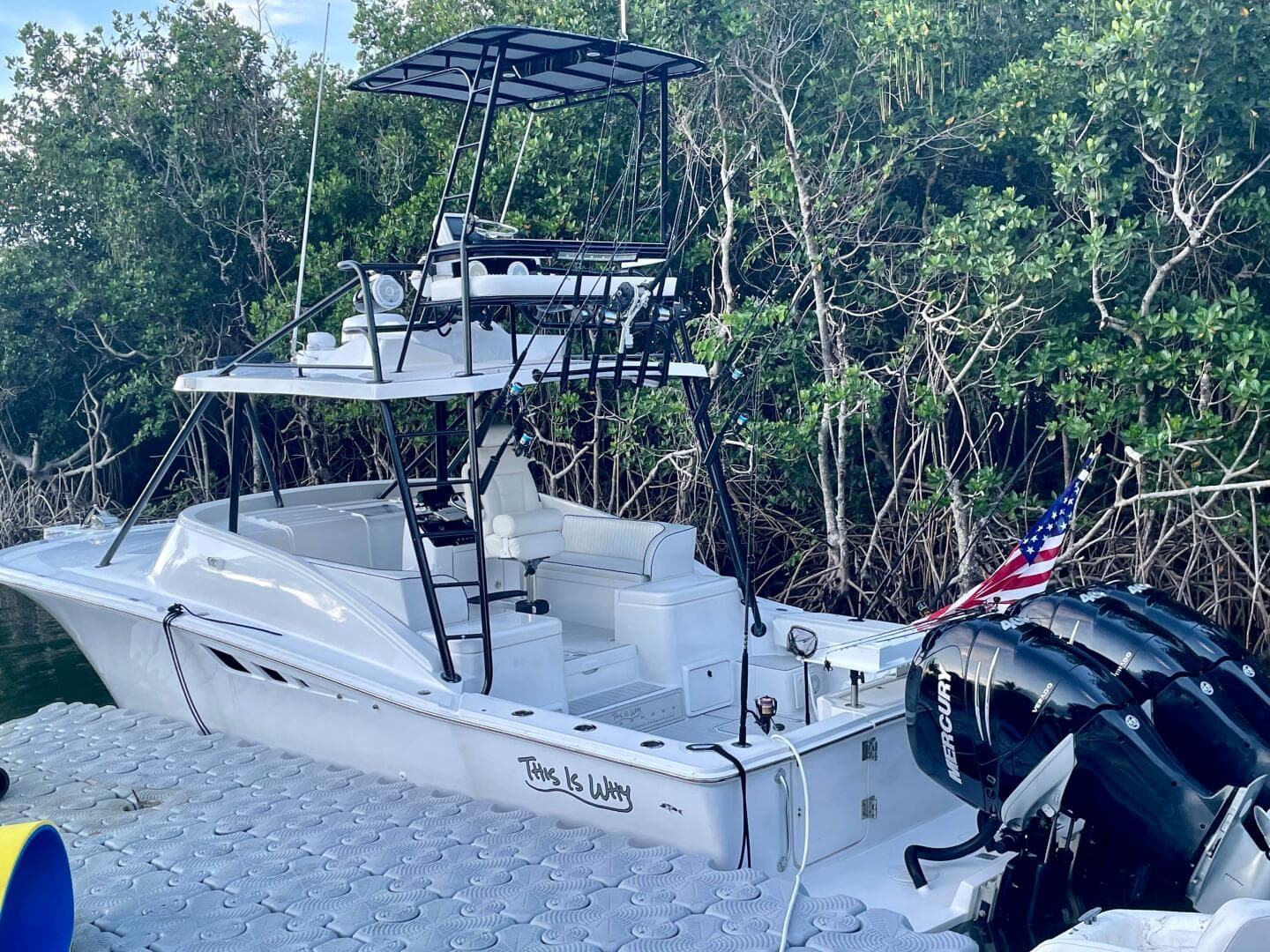 2000 Luhrs Tournament 320 Open boat docked near mangroves with dual Mercury outboard engines.