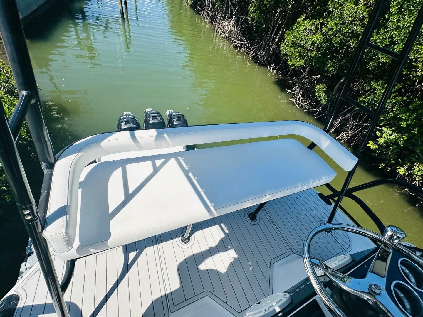 2000 Luhrs Tournament 320 Open boat, rear deck view with white seating and water backdrop.