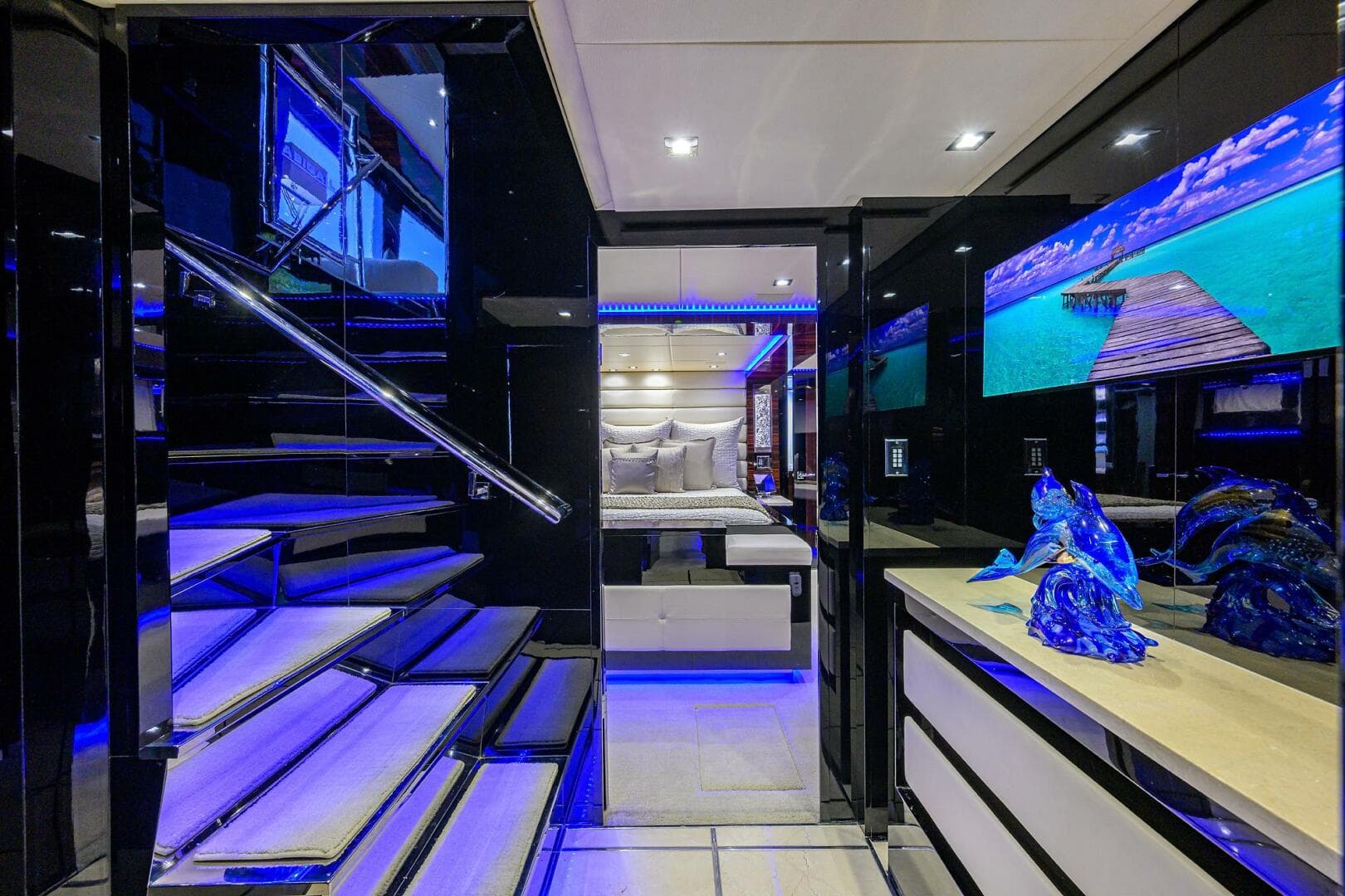 Luxurious interior of 1997 Broward 108 Raised Pilothouse yacht with modern decor and blue lighting.