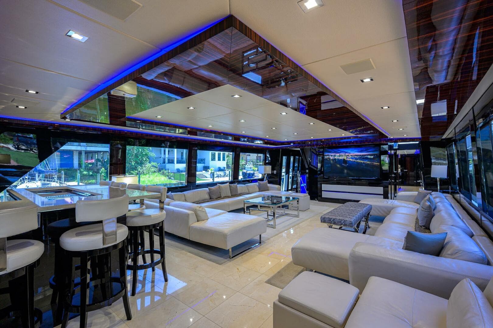 Luxurious interior of 1997 Broward 108 Raised Pilothouse yacht with modern white seating.