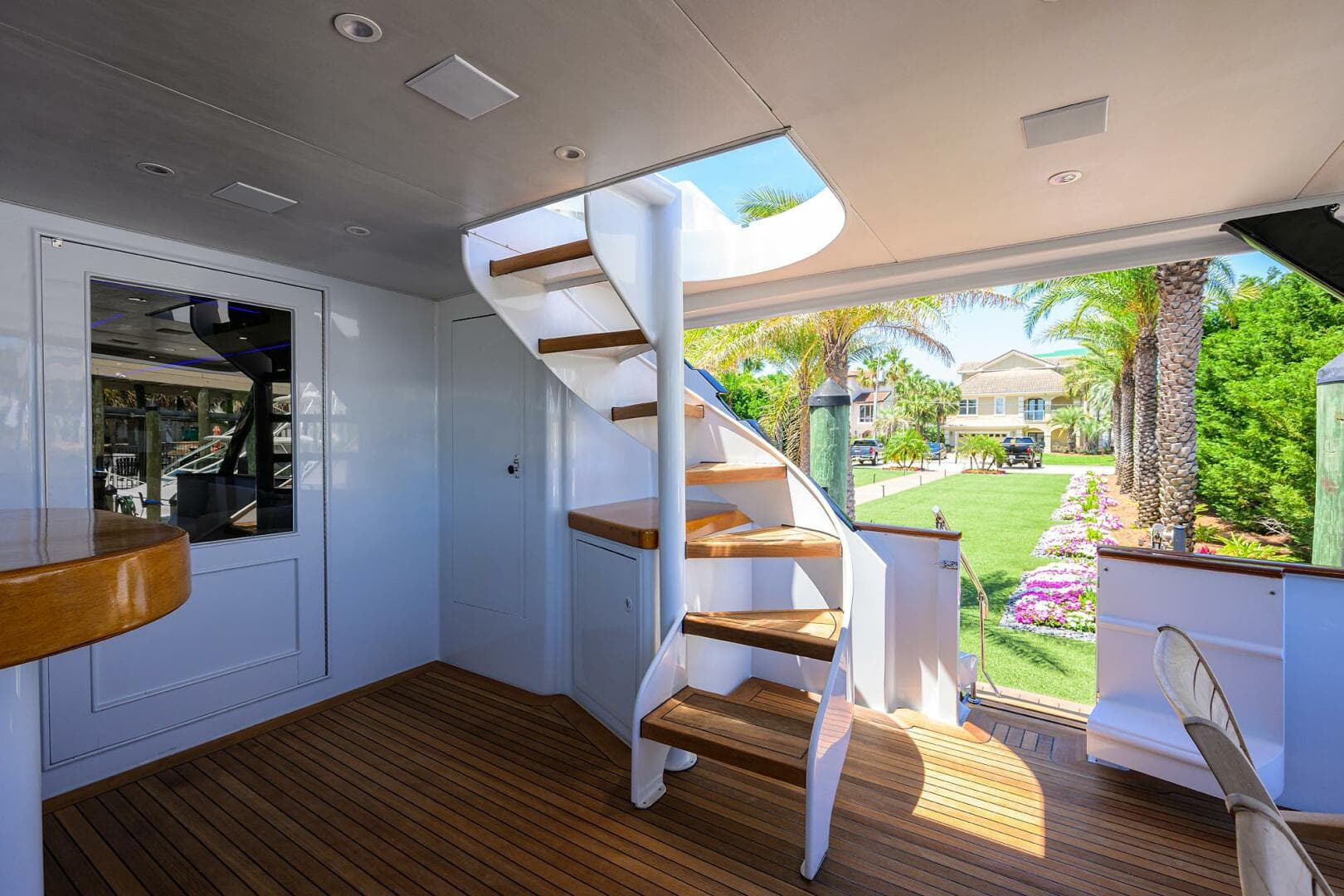 Interior of 1997 Broward 108 Raised Pilothouse yacht with wooden stairs and deck.