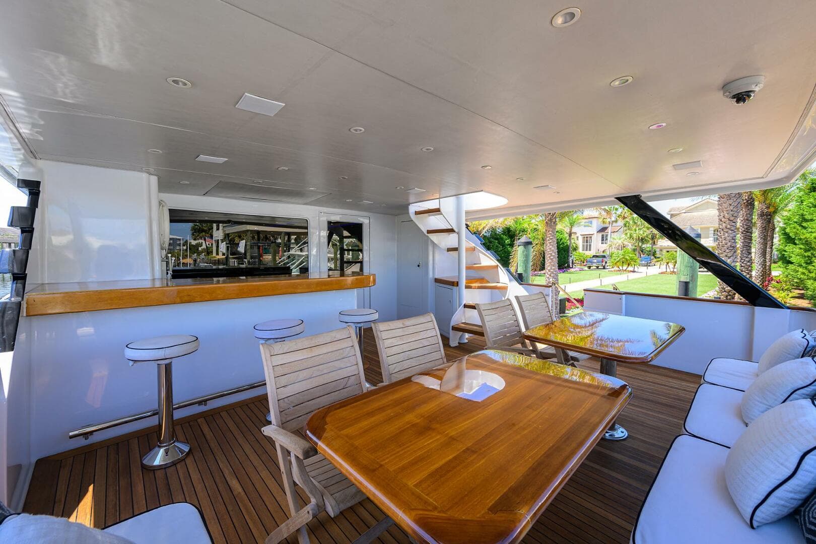 Spacious deck of 1997 Broward 108 Raised Pilothouse yacht with seating and bar area.