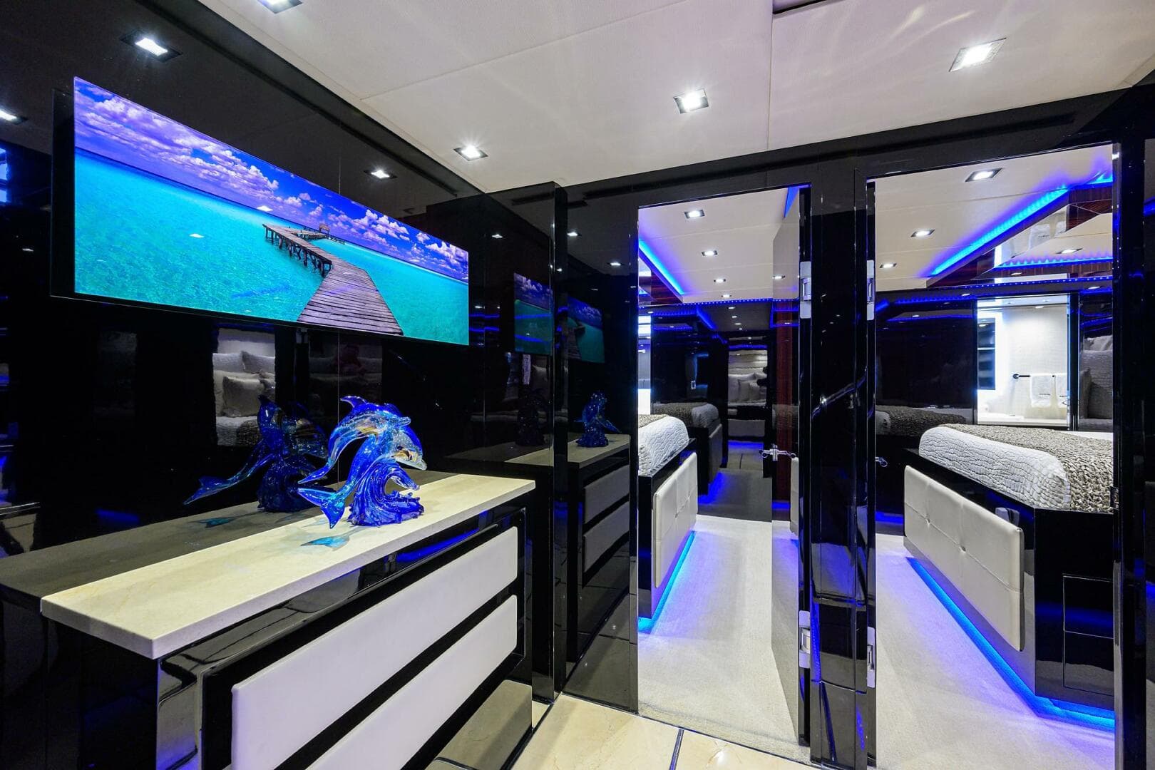 Luxurious interior of 1997 Broward 108 Raised Pilothouse yacht with modern decor and blue LED lighting.