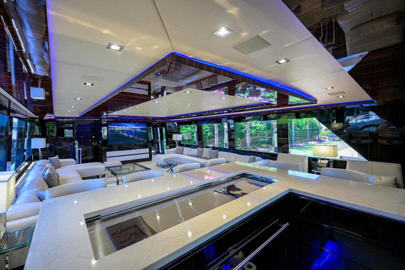 Luxurious interior of 1997 Broward 108 Raised Pilothouse yacht with modern design and ample seating.