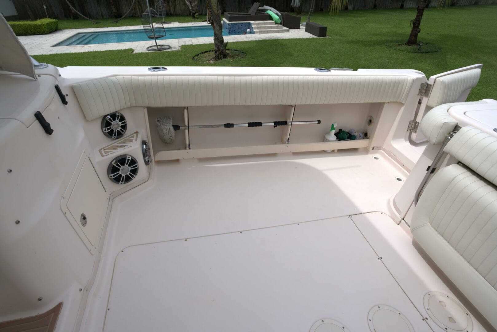 2007 Grady-White Express 330 boat interior with seating and speakers, near a pool.