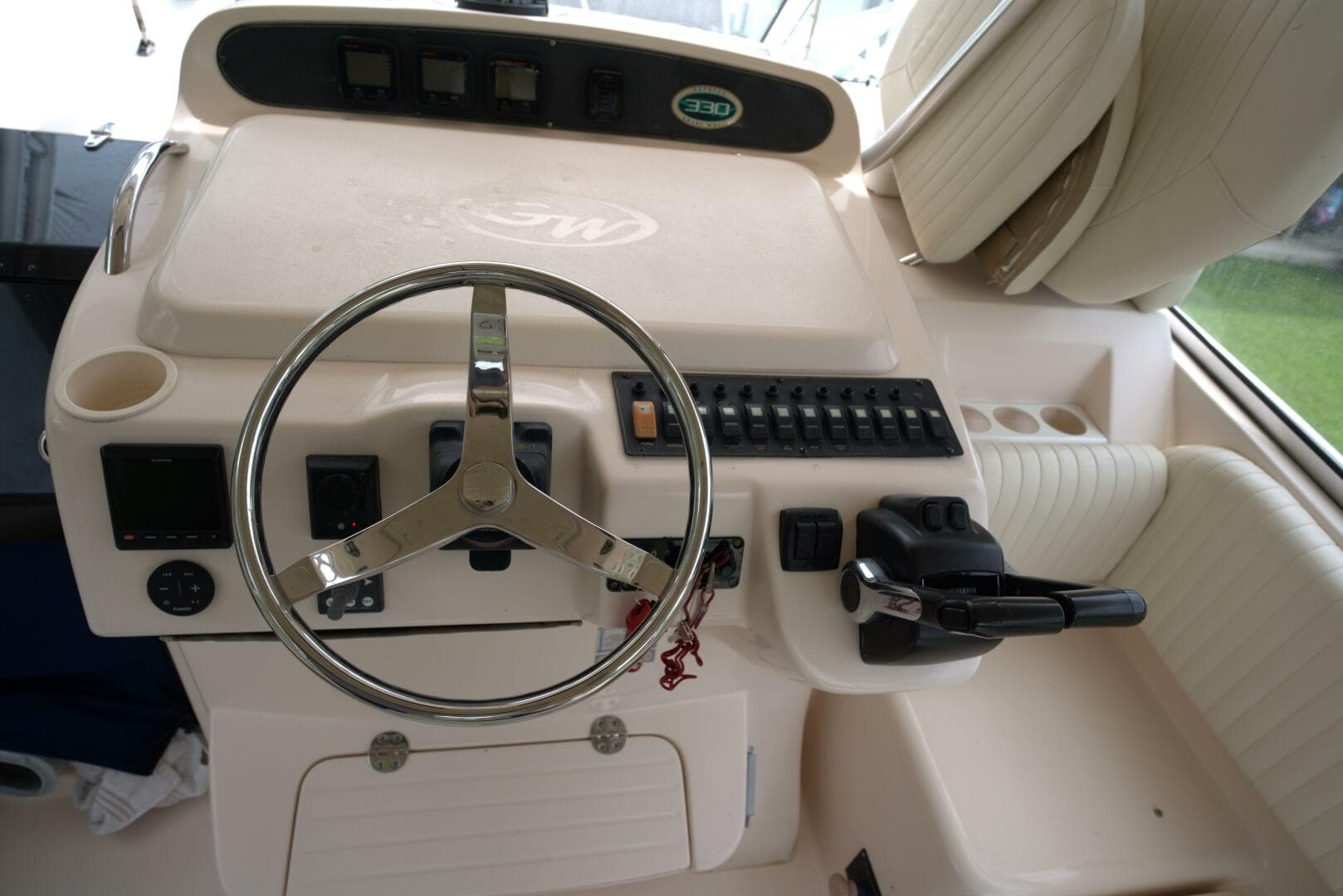 2007 Grady-White Express 330 helm with steering wheel and control panel.