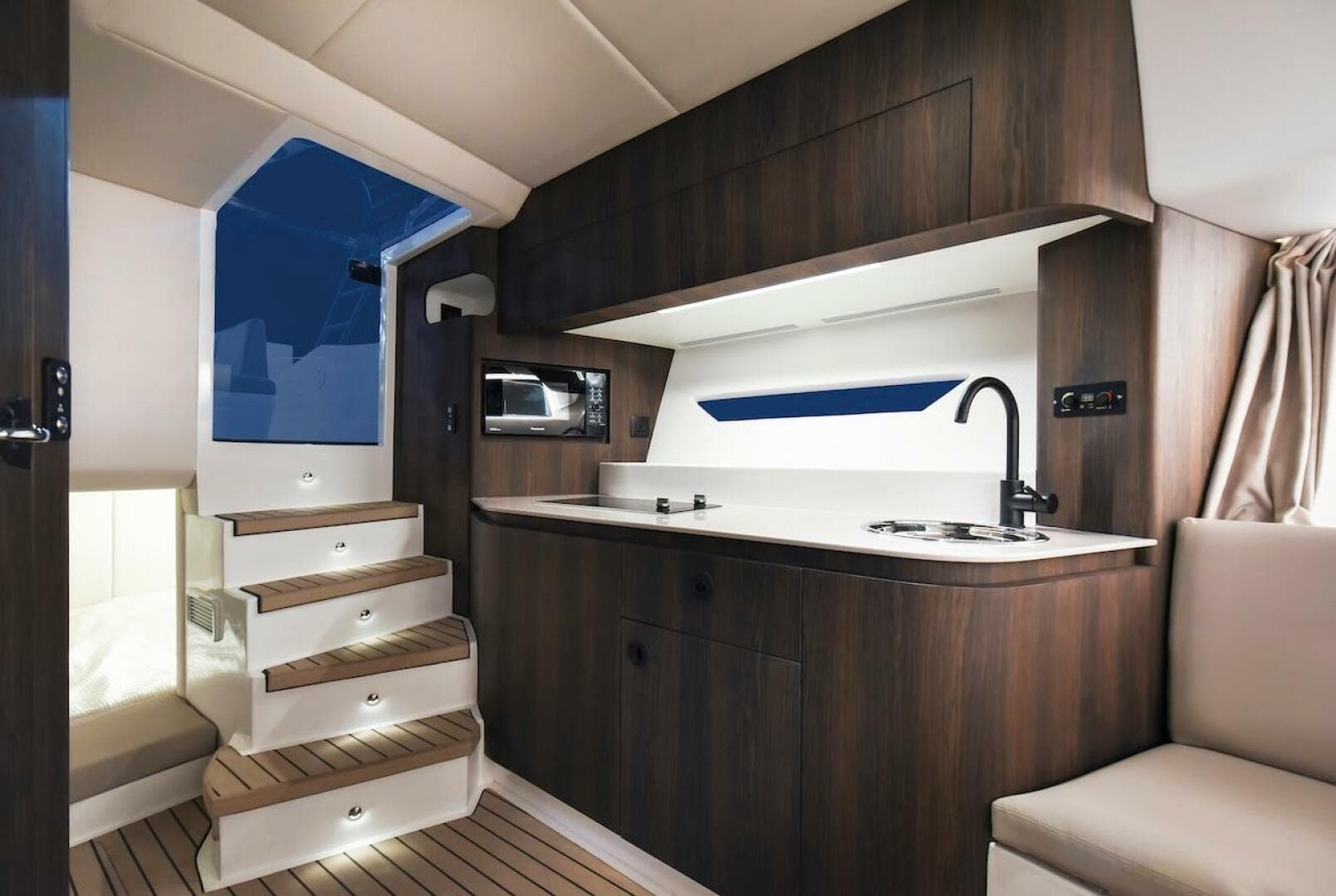 2024 Oryx 379 yacht interior with modern kitchen and wooden stairs.