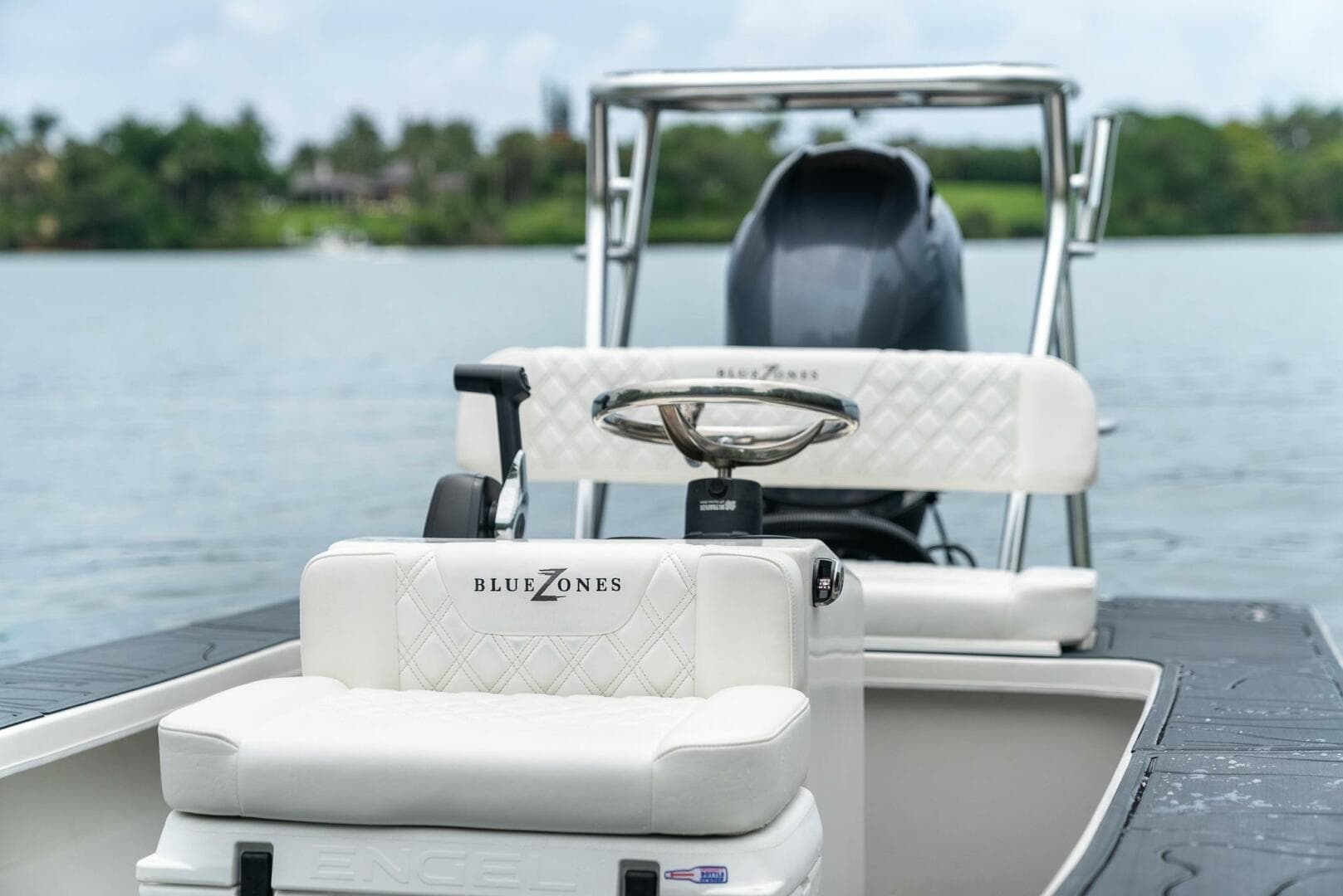 2025 BlueZones Boatworks 16' Flats boat on calm water, featuring sleek design and comfortable seating.