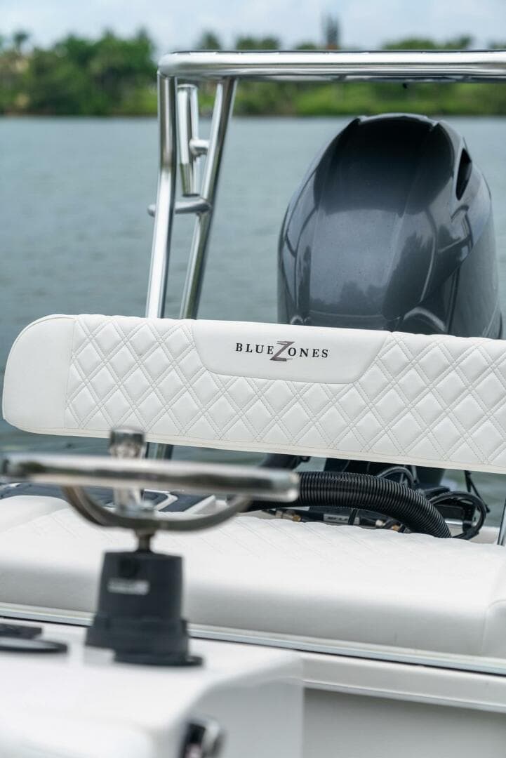 2025 BlueZones Boatworks 16' Flats boat with sleek design and powerful engine on water.
