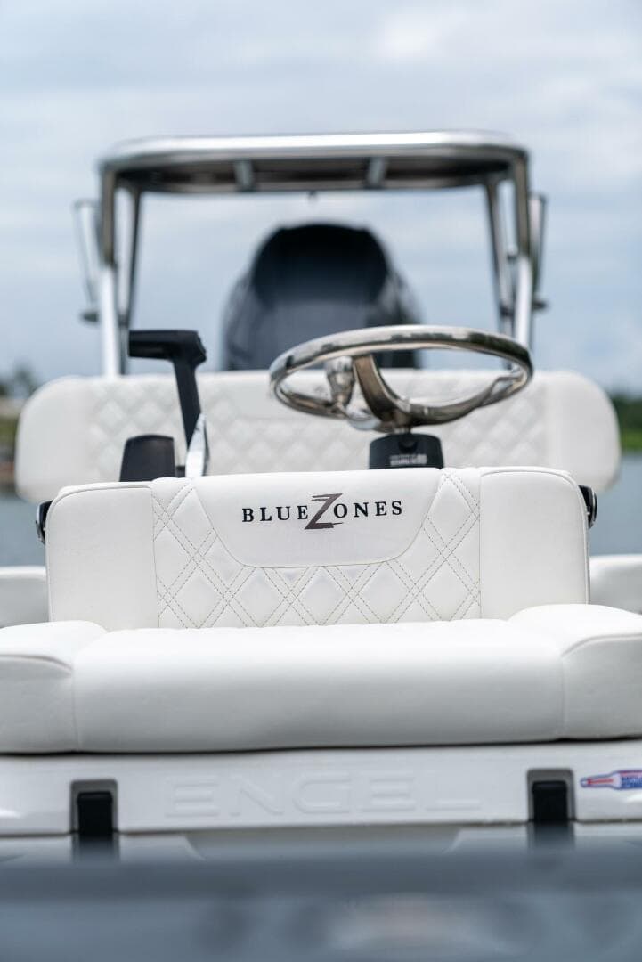 2025 BlueZones Boatworks 16' Flats boat interior with steering wheel and seating.