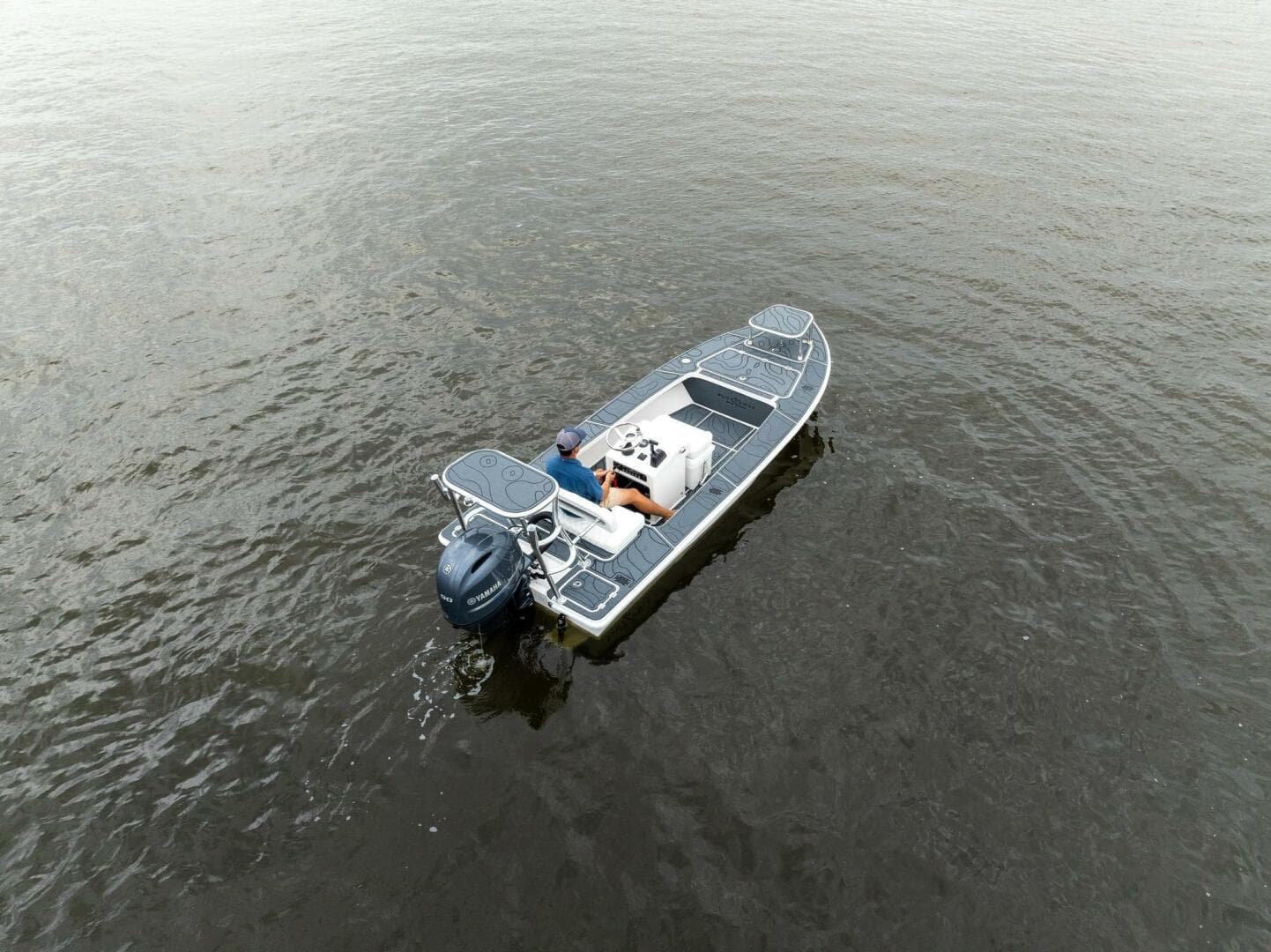 2025 BlueZones Boatworks 16' Flats on calm water, aerial view.