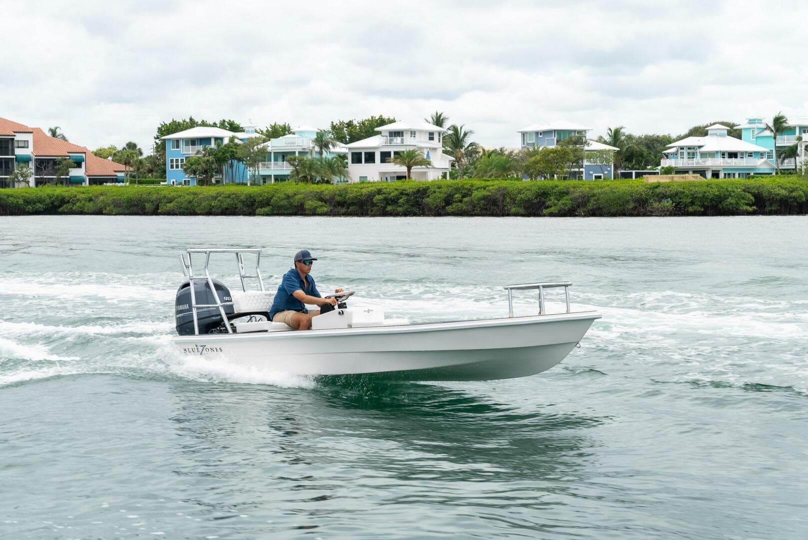 2025 BlueZones Boatworks 16' Flats cruising on a scenic waterway.