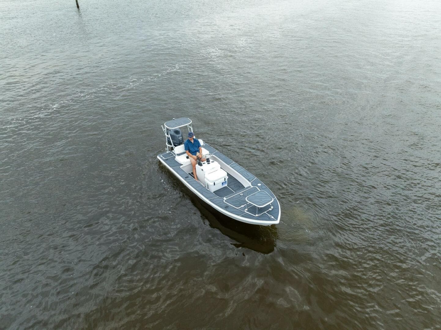 2025 BlueZones Boatworks 16' Flats boat on calm water, aerial view.