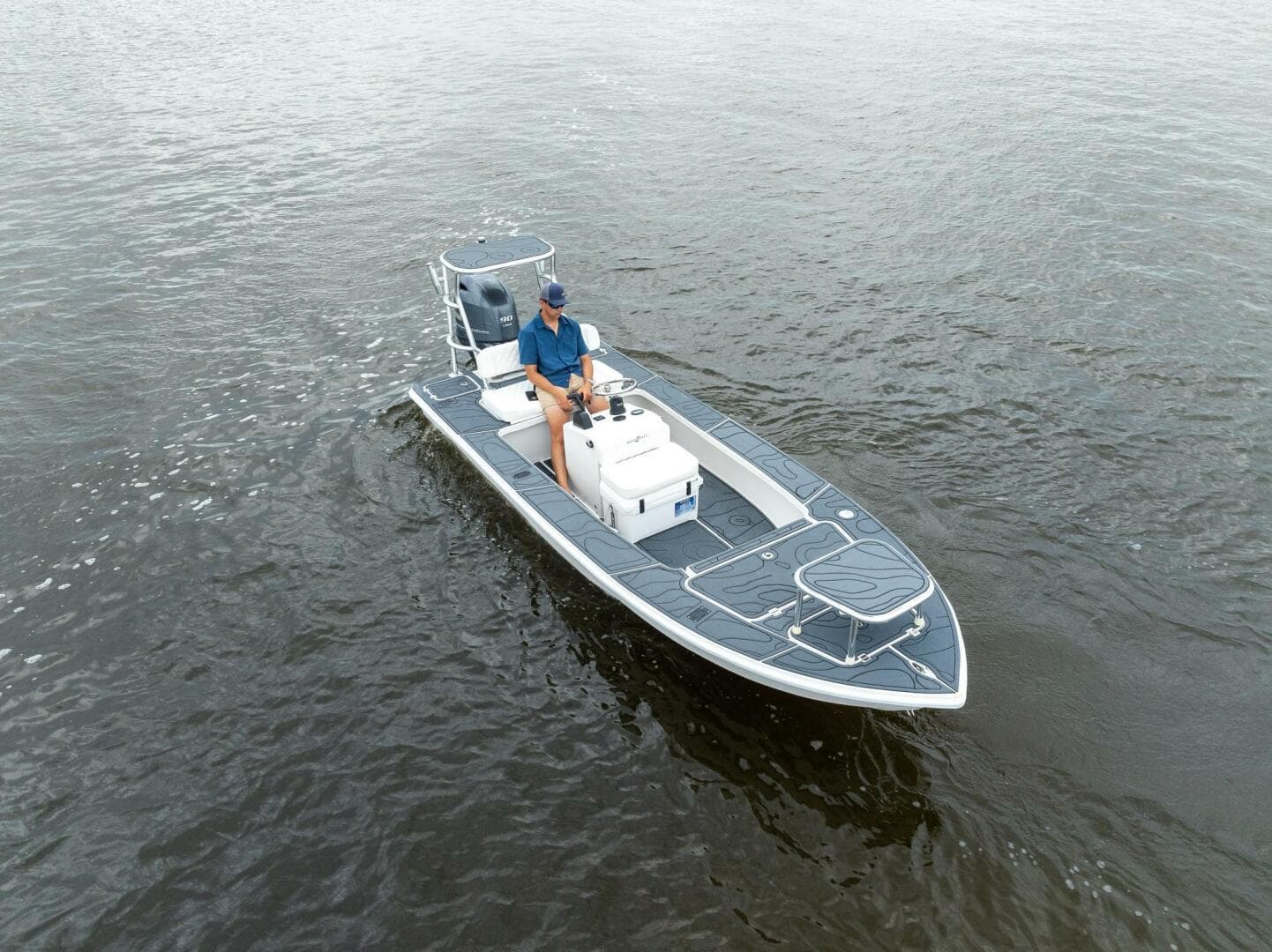 2025 BlueZones Boatworks 16' Flats boat on water, featuring sleek design and modern features.