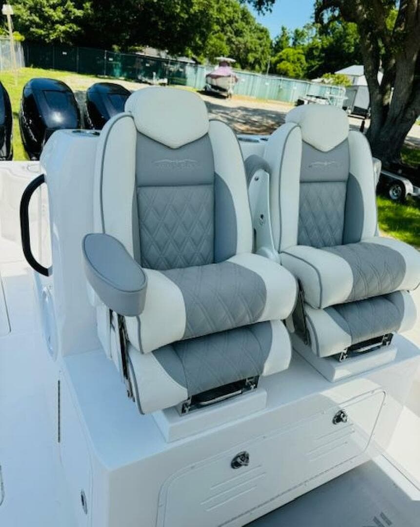 2022 Invincible 36 Open Fisherman boat seats, gray and white upholstery, outdoor setting.