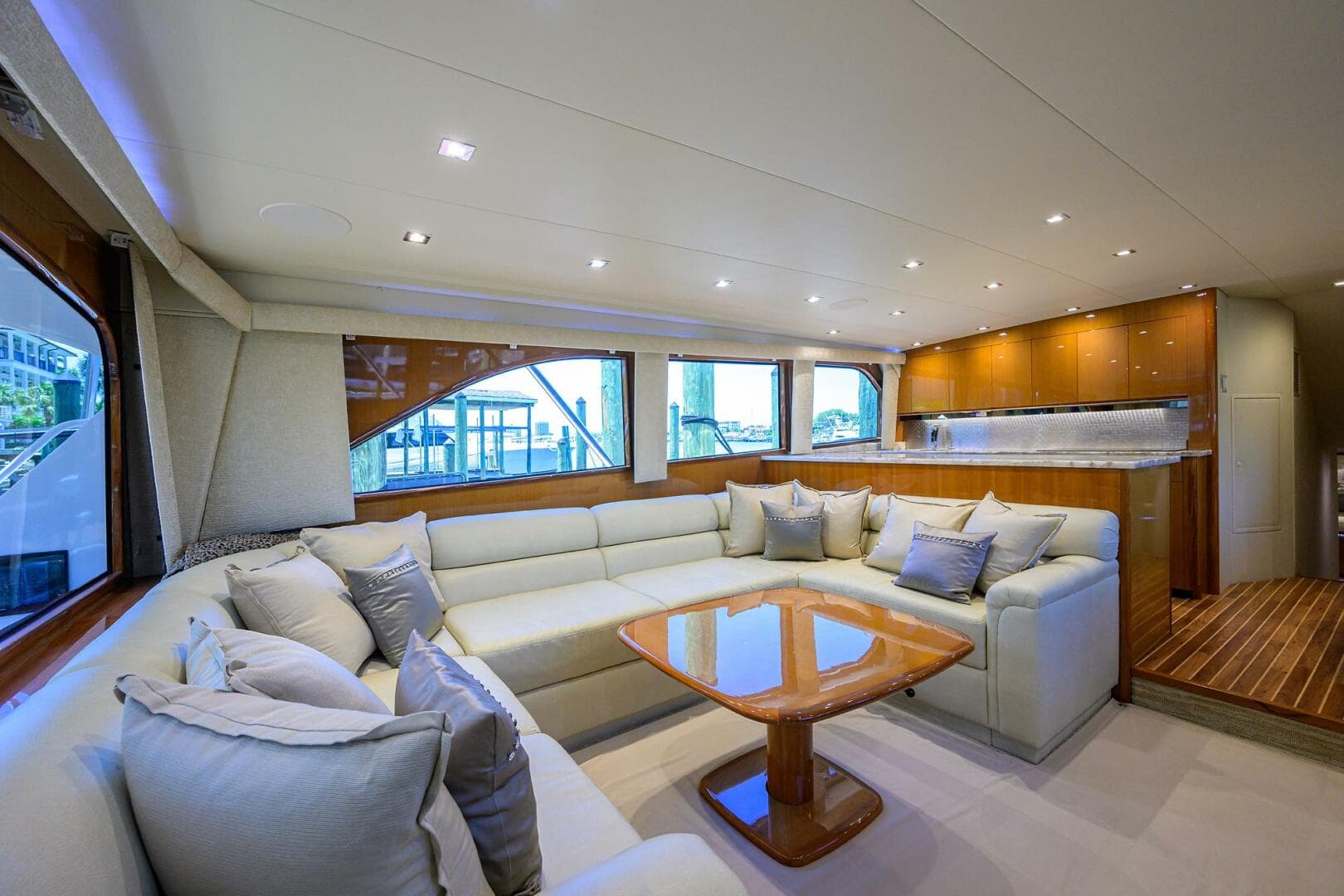 Luxurious interior of 2004 Viking 65 Enclosed Bridge yacht with spacious seating and modern kitchen.